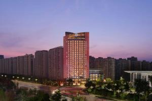 a tall building with a clock on top of it at Sheraton Tengzhou in Zhaozhuang