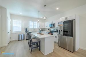 a kitchen with white cabinets and stainless steel appliances at Pooley Pad in American Fork +26 photos