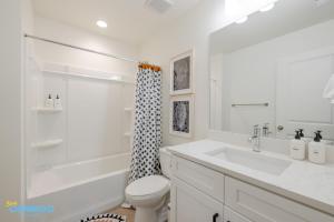 a white bathroom with a sink and a toilet at Pooley Pad in American Fork