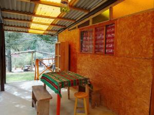 a room with a table and a stool in a room at Tony's House Eco Hostel in Huaraz