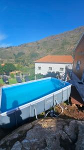 a swimming pool sitting on top of a rock at Piscinas, Serra da Estrela AL in Bouça