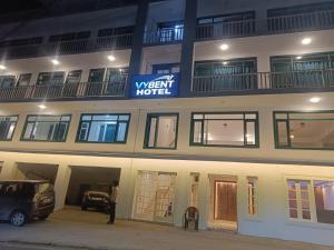 a man standing in front of a hotel at night at Vybent hotel kainchi dham in Bhowāli