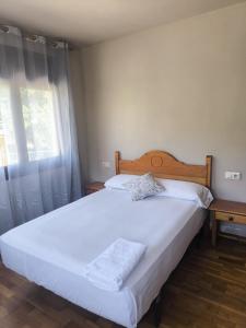 a bedroom with two beds and a window at ARES Ecoresort in Camarasa