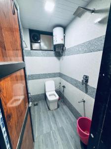 a small bathroom with a toilet and a sink at Shree Vishwakarma place in Khātu