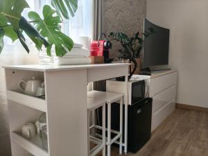 a white table with a plant on top of it at Studio with private pool in Villefranche-sur-Mer