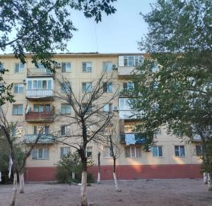 an apartment building with trees in front of it at ИП Саялы in Balqash