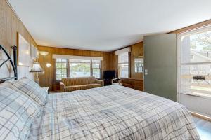 a bedroom with a bed and a chair and a window at King Birch Lake Home, Unit 10 in Alton
