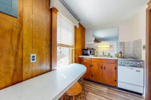 a kitchen with a white counter top and wooden cabinets at King Birch Lake Home, Unit 10 in Alton +7 photos