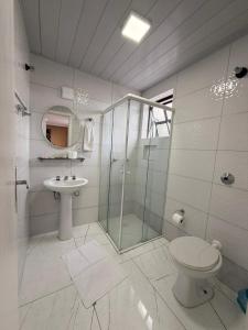 a bathroom with a shower and a toilet and a sink at Hotel Estação Express in Curitiba +139 photos