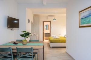 a room with a bed and a table and chairs at Raggio di Sole Ulassai in Ulassai