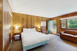 a hotel room with a bed and a couch at King Birch Lake Home, Unit 5 in Alton