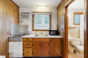 a small kitchen with a sink and a stove at King Birch Lake Home, Unit 5 in Alton