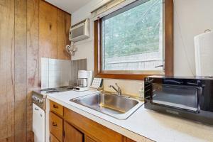 a kitchen with a sink and a microwave at King Birch Lake Home, Unit 5 in Alton +9 photos