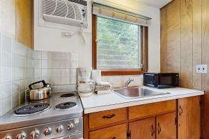a kitchen with a sink and a stove top oven at King Birch Lake Home, Unit 7 in Alton