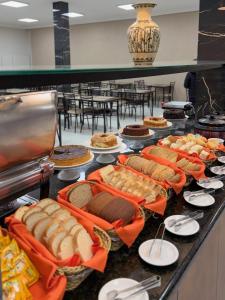 a buffet with a lot of sandwiches and pies at Hotel Estação Express in Curitiba