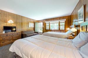 a large bedroom with two beds and a television at King Birch Lake Home, Unit 3 in Alton