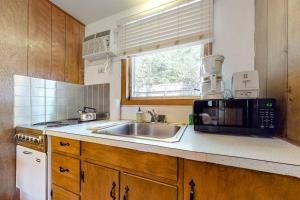 a kitchen with a sink and a microwave at King Birch Lake Home, Unit 3 in Alton