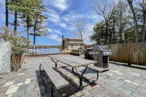 a picnic table and a grill on a brick patio at King Birch Lake Home, Unit 3 in Alton
