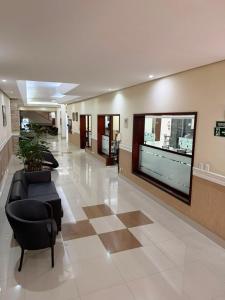a lobby with couches and a tv in a building at Hotel Estação Express in Curitiba