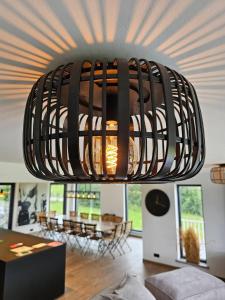aendant light hanging from the ceiling of a living room at Les Terrasses de Laloux in Rochefort +24 photos