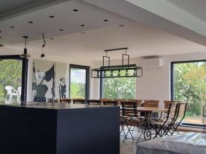 a kitchen and dining room with a table and chairs at Les Terrasses de Laloux in Rochefort