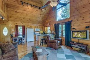 a living room and kitchen in a log cabin at Treetops Hot Tub Fire Pit Pool Table in Copperhill