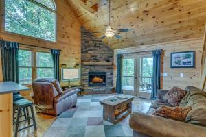 a living room with a couch and a fireplace at Treetops Hot Tub Fire Pit Pool Table in Copperhill