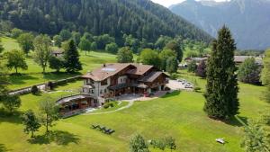 an aerial view of a large house on a green field at Hotel Maso del Brenta in Caderzone Terme