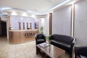 a lobby of a hotel with a couch and a table at Time Stay Hotel in Yerevan