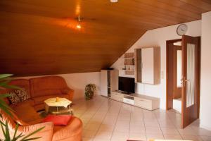a living room with a couch and a table at Haus Heinzmann in Bad Schonborn