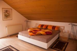 a bedroom with a bed with a wooden ceiling at Haus Heinzmann in Bad Schonborn