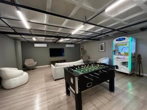 a living room with a foosball table and a soda machine at Beach Class Executive - Flats no Pina por Yolo in Recife