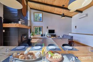 a dining room with a table with food on it at Chalet L'Ascension in Saint-Philémon