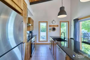 a kitchen with a sink and a counter top at Chalet L'Ascension in Saint-Philémon +49 photos