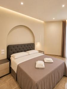 a bedroom with a large bed with two towels on it at Villa Elysia Tropea in Tropea