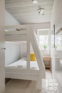a white bunk bed in a white room at The Red Deer Lodge in Tällberg