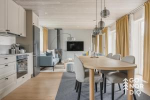 a kitchen and dining room with a table and chairs at The Red Deer Lodge in Tällberg