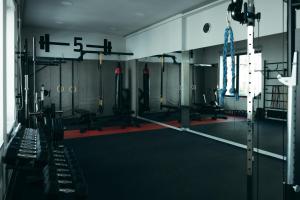 a gym with treadmills and machines in a room at Stay Swanky Hostel in Zagreb