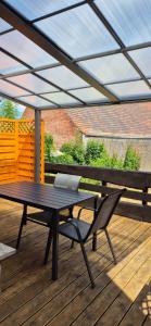 a patio with a table and a laptop on a deck at Lindenplatz 6 in Sondershausen
