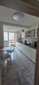 a kitchen with a table and a dining room at Lindenplatz 6 in Sondershausen