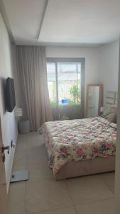 a bedroom with a bed and a window at Les belles terrasses mansouria in Mansouria