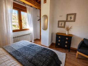 a bedroom with a bed and a mirror and a chair at Jaricha in Cabezas Altas