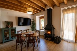 a dining room with a table and a wood stove at Jaricha in Cabezas Altas