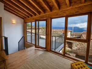 a room with a balcony with a large window at Jaricha in Cabezas Altas +10 photos