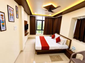 a bedroom with a bed in a room at Parth Paradise Hotel in Indore