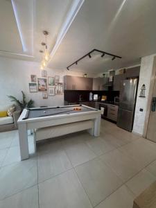 a large living room with a pool table in it at Les belles terrasses mansouria in Mansouria