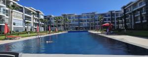 a large swimming pool in front of a building at Les belles terrasses mansouria in Mansouria +7 photos