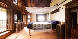 a bedroom with a bed with a canopy at The Famous Farm in Nawākot