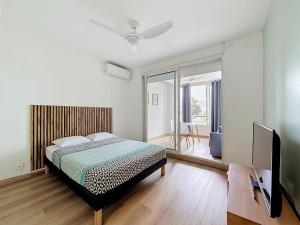 a bedroom with a bed and a flat screen tv at studio cosy - champ fleuri in Sainte-Clotilde