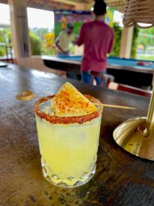 a drink with a piece of cheese on a table at The Mountainstream Lodge in Lethem